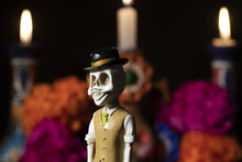 Closeup Shot Of Plastic Skulls Figurine With A Hat For An Offering Of The Day Of The Dead