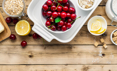 Poster - Raw ingredients for cooking cherry pie on wooden table top view