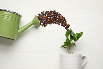 Wall Mural - Composition with coffee tree, beans and watering can on light wooden background, closeup