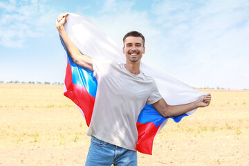 Wall Mural - Young man with national flag of Russia outdoors