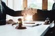 © Jirapong - Law, consultation, agreement, contract, lawyer or attorney shakes hands to agree on the client's offer to be hired to fight the parties in court.