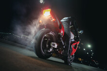 Motorbiker Is Burning A Tire Rubber On Night Road.
