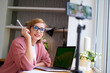 © khmelev - Female blogger recording vlog video live streaming and making a video. Business online influencer on social media concept. Online Selling. Online Shopping