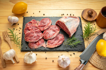 Wall Mural - Premium Shank beef in black stone plate on wooden background.Fresh Silver shank meat in black plate on wooden background. 