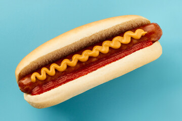 Wall Mural - Classic hot dog with wurst, ketchup and mustard on blue background. Menu for restaurant