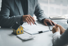 Real Estate Broker Agent Being Analysis And Making The Decision A Home Estate Loan To Customer To Signing Contract Documents For Realty Purchase, Get Insurance Or Loan Real Estate Or Property.