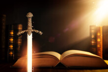Photo Of Sword And Old Books Over Dark Background. Medieval Period Concept
