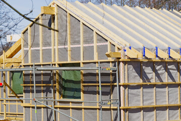 Wall Mural - Single Family Home Construction. Interior frame of new wooden house under construction. house under construction with the roof structure of wood. construction frame house made of wood, with roof