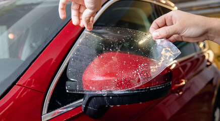 Master man installs vinyl film in risk zone of windshield to protect car body paint