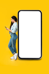 Happy lady using mobile phone at studio