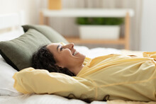 Smiling Woman Having Rest At Home Lying On Bed