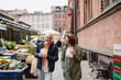 © Halfpoint - Happy senior couple tourists with snack in town on outdoor market.