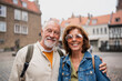 Leinwandbild Motiv Happy senior couple tourists outdoors in historic town