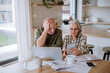 © Halfpoint - Stressed senior couple calculate expenses or planning budget together at home.