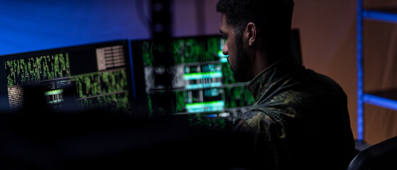 Hacker in military unifrorm on dark web, cyberwar concept.