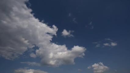 Wall Mural - clouds in the blue sky on a summer day timelapse