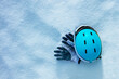 Sport gloves in the snow with blue ski helmet and mask