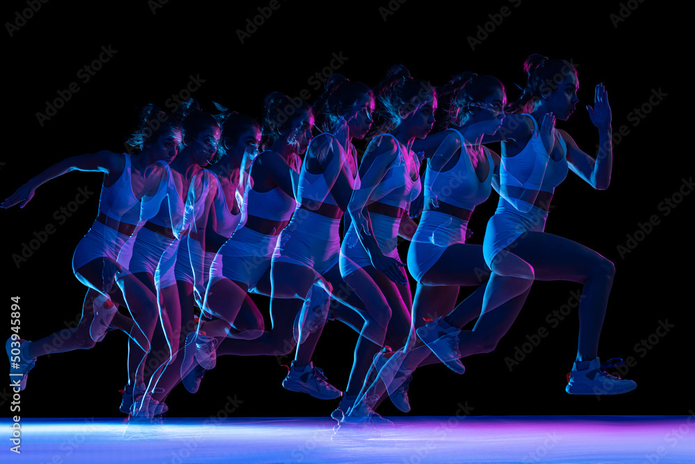 Development of movements. Professional female athlete, runner training isolated on dark background with stroboscope effect.