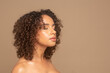© Cultura Creative - Studio shot of woman with curly hair and eyes closed