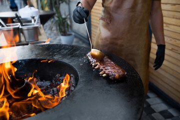 Grilled pork baby ribs with barbecue sauce on the grill. Festival street food