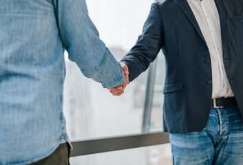 Wall Mural - Close up shot of businessmen entrepreneurs freelancers shaking hands greeting each other making a successful new deal and start of collaboration on the new mutual project