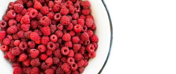 Wall Mural - raspberry bowl full of fresh raspberries on white background