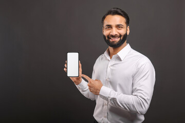 mock-up concept. handsome confident bearded indian man in formal wear showing smartphone with empty 