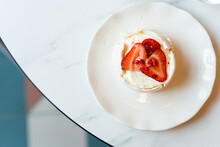 Overhead View Of A Plate With A Meringue Cake With Fresh Strawberries