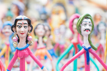 Wall Mural - Colorful dolls made of clay, handicrafts on display during the Handicraft Fair in Kolkata , earlier Calcutta, West Bengal, India. It is the biggest handicrafts fair in Asia.