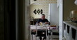 © Marco - Lonely older man eating lunch alone in home kitchen