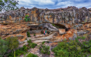Wall Mural - Aerial view of a woman and a man in the rock arch on Cerro Arco in Tobati in Paraguay.