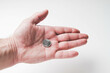 © Verrone - Coins in the palm of your hand. Poverty and depreciation. Minimum wage.