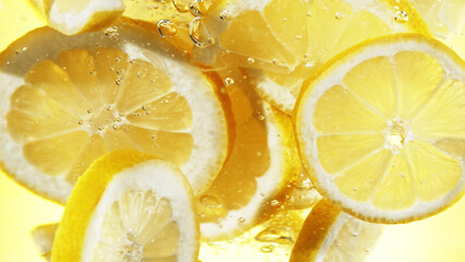 Wall Mural - Close up of lemon slices in water.