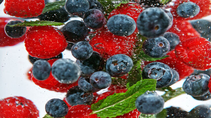 Wall Mural - Close up of various kind of berries in water.