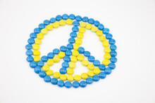 The Peace Sign Made Of Circle Chocolate Blue And Yellow Color Isolated On White Background. Colors Of Flag Of Ukraine. Peace And Claim Cessation Of War Concept. Get Pacification Back To The World
