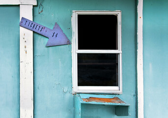Wall Mural - Dilapidated, abandoned go kart ticket booth arrow.