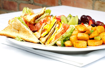 Wall Mural - Breakfast club sandwich and assorted fruits