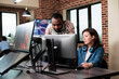 © DC Studio - African american company coworker standing near production department team leader desk while discussing. Digital graphic artist with colleague talking about future of project.