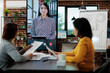© DC Studio - Businesswomen collaborating together at management project discussing business ideas during online videocall meeting conference in startup office. Teleconference call on monitor screen