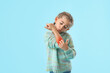 © Pixel-Shot - Little girl with allergy scratching herself on light blue background