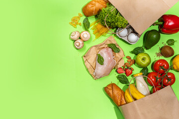 Fresh vegetables, meat, bread fruits in paper grocery bag. Delivery healthy food background. Healthy food cooking ingredients on white,background, Shopping food supermarket and clean vegan eating