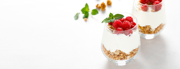 Poster - Granola with white plain yogurt and raspberry in a glass. Banner