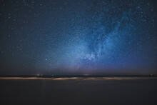 Night Skyscape Of A Starry Sky At The Seashore. Stars Constellations And Milky Way Galaxies In The Night Sky. Concept Of Dreaming And Stargazing.