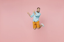 Full Body Young Excited Fun Man 20s Wear Classic Blue Shirt Jump High Point Index Finger Aside On Workspace Area Mock Up Isolated On Plain Pastel Light Pink Background Studio People Lifestyle Concept