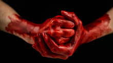 Women's Fists In Blood On A Black Background. Fist And Palm. 