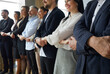© Studio Romantic - Human support. Happy successful group of business people standing in row and holding hands as symbol of unity. Cropped image business partners demonstrate unity and teamwork. Selective focus.