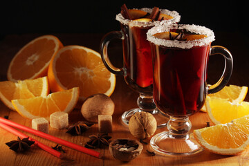 Wall Mural - Two cups with ready mulled wine with anise, cinnamon and nuts around