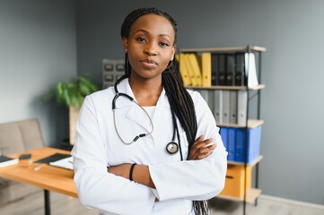 Wall Mural - Portrait Of Female Doctor Wearing White Coat In Office.