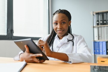 Wall Mural - happy young african female nurse working in office.