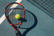 Overhead view of red tennis racket on ball and court with line during sunny day
